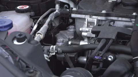 Mechanic checking car engine oil level with yellow dipstick 库存影片 331482977