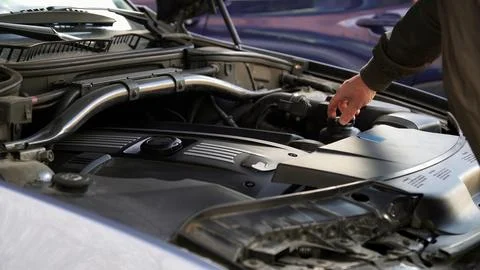 Mechanic checking car engine oil level Stock Photos