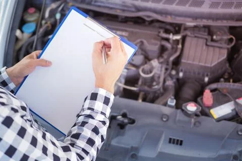 The mechanic is checking the condition. Write down the maintenance items on t Stock Photos