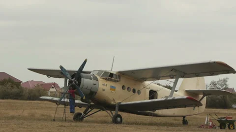 Mechanic checking engine of an old Soviet aircraft Antonov An-2R, also known as  Stock Footage 38391025
