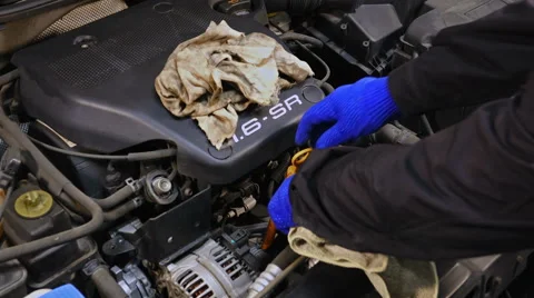 Mechanic checking the motor oil Stock Footage 61628122