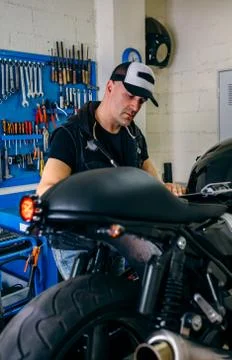 Mechanic checking motorcycle Stock Photos
