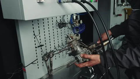 Mechanic checking the pressure inside the steering tie rod on a specialized Stock Footage 281581544