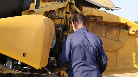 Mechanic checking tractor engine Stock Footage 77848842