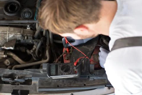 Mechanic checks electronics accumulator Stock Photos