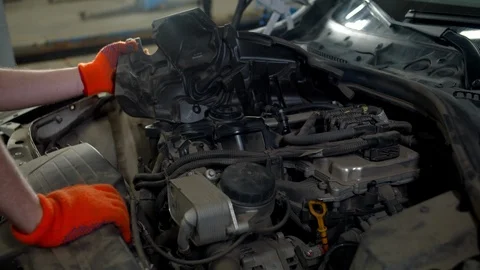 Mechanic checks the engine of a car, close up Stock Footage 124267089