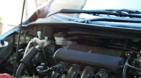 A mechanic checks the level of engine oil in a vehicle. Stock Footage 58693053