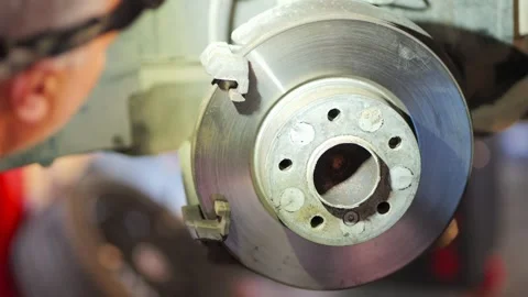 Mechanic Cleaning Brake Disc with Wire Brush Close Up, 2026 Video stock 331675366