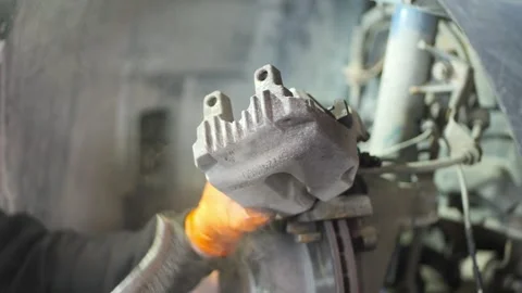 Mechanic Cleaning Brake Disc with Wire Brush Close Up Stock Footage 331675383