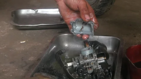 A mechanic is cleaning dirty motorcycle engine parts. Video stock 324942131