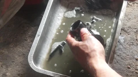 A mechanic is cleaning dirty motorcycle engine parts. Video stock 324942168