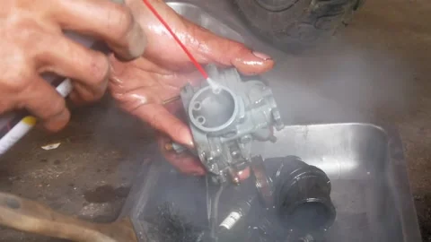 A mechanic is cleaning dirty motorcycle engine parts. Video stock 324942180