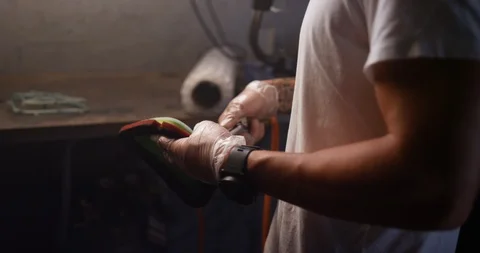 Mechanic cleaning motorcycle part with pipe nozzle in shop Stock Footage 116361920