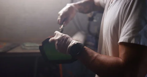 Mechanic cleaning motorcycle part with pipe nozzle in shop Stock Footage 116361995