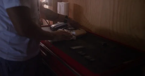 Mechanic cleaning the outer part of motorcycle in shop Stock Footage 116361684