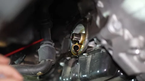 Mechanic cleans the engine block before installing new oil filter. Stock Footage 345708259