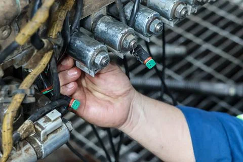 Mechanic Connecting Wire Plug to Transmission Solenoid Valve. Stock Photos