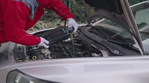 The mechanic constantly pours without stopping new Oil Stock Footage 260617274