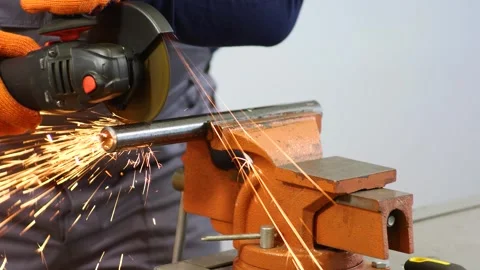 Mechanic cuts a pipe with a grinder Stock Footage 279074340