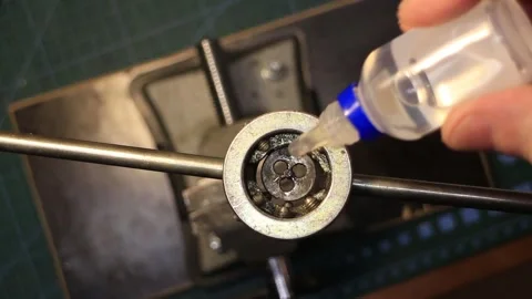 A mechanic cuts a thread Video stock 267620944