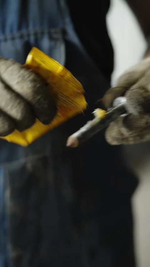 Mechanic in dirty work gloves applying grease to metallic bolt Stock Footage 337569019
