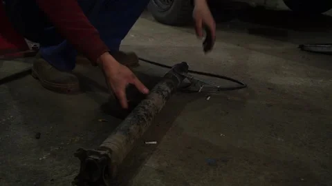 A mechanic disassembles an old dirty car Видео 221433645
