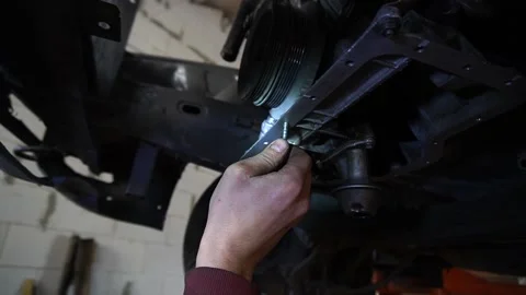 A mechanic disassembles an old dirty car Stockbeeldmateriaal 221433661