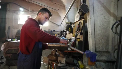 A mechanic disassembles an old dirty car Видео 221433889