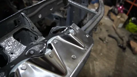 A mechanic disassembles an old dirty car 動画素材 221433953