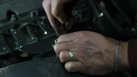 A mechanic disassembles an old dirty car Stock Footage 222888652