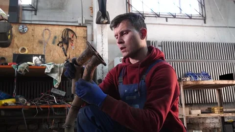A mechanic disassembles an old dirty car Stock Footage 222888841