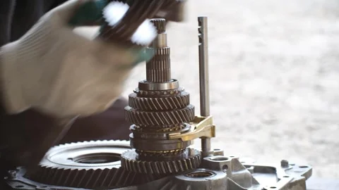 Mechanic disassembling car transmission gearbox shaft Stock Footage 318947062