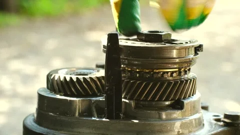 Mechanic disassembling manual car transmission gears Stock Footage 318918222