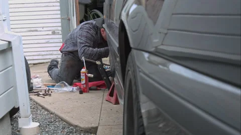 Mechanic Doing A Brake Job On An E39 Bmw 540I Video stock 49094147