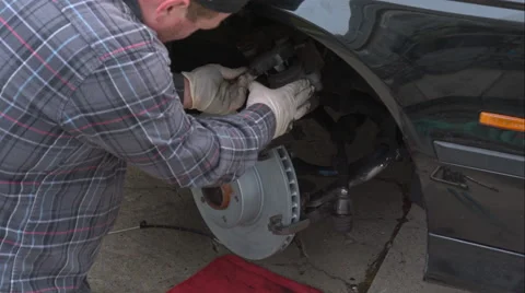Mechanic Doing A Brake Job On An E39 Bmw 540I Stock Footage 49095132