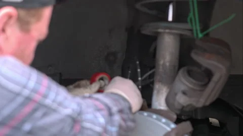 Mechanic Doing A Brake Job On An E39 Bmw 540I Stock Footage 49095199