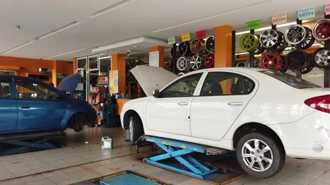 A mechanic doing a car maintenance at workshop. Stock Footage 135790643
