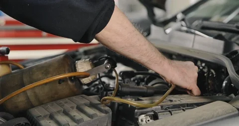 Mechanic Draining Old Brake Fluid From A System During The Service Video stock 124956299