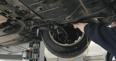 Mechanic Draining Old Brake Fluid From A System During The Service. Close Up Video stock 124957445