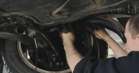 Mechanic Draining Old Brake Fluid From A System During The Service. Close Up Video stock 124958010