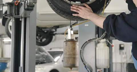 Mechanic Draining Old Brake Fluid From A System. Detail Shot Of The Can Video stock 124958100