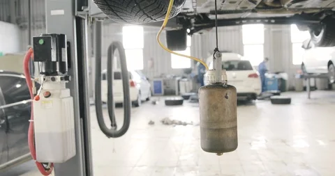 Mechanic Draining Old Brake Fluid From A System. Detail Shot Of The Canister.  Stock-Footage 125011528