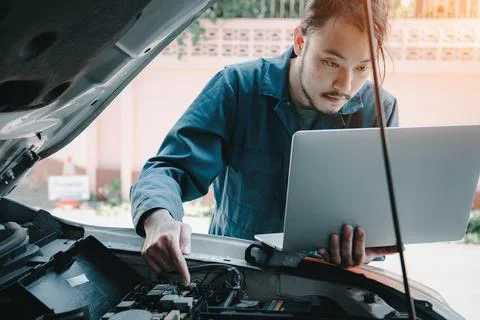 Mechanic Engineer is Diagnosing Car Engine and Electric Adjusting Transmissio Stock Photos