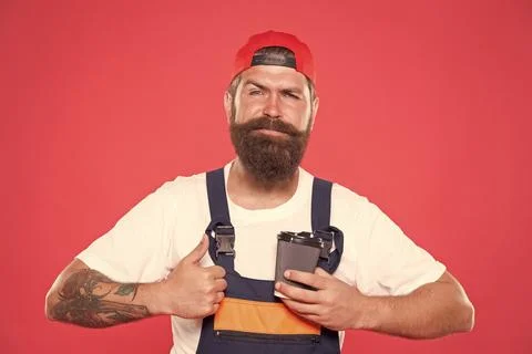 Mechanic enjoy coffee. Handsome builder hold coffee cup. Energy concept Stock Photos