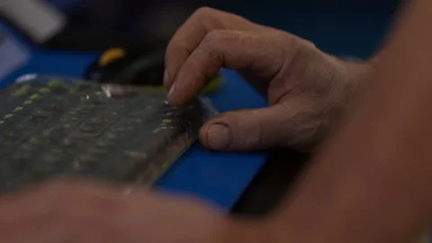 Mechanic entering test parameters on automotive diagnostic bench close up Stock Footage 345173334