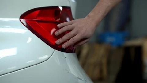 Mechanic examines damage and touches a car Stock Footage 124253249
