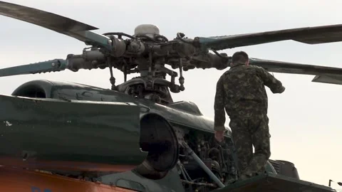Mechanic examines engines of Mi-8 helicopter (Hip) after flight. Stock Footage 139806983