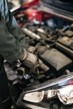 Mechanic examining and maintenance the engine car Stock Photos