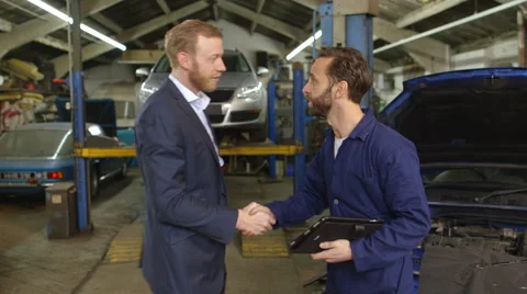 Mechanic explaining car repairs to an upset customer Stock Footage 46311529