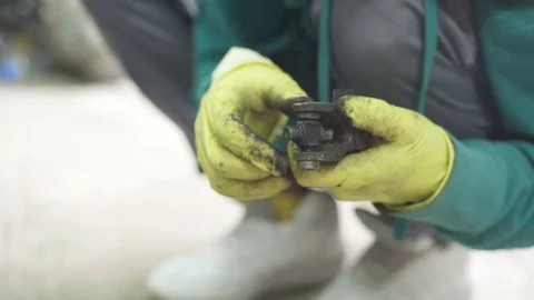 Mechanic figuring out problem with ball bearing cross joint Stock Footage 128921342